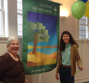 Two members displaying the new Live Oak banner.